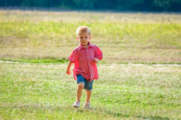 A Happy child playing in nature in summer