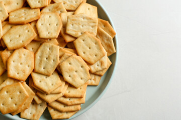 Top view delicious crackers on light table, closeup