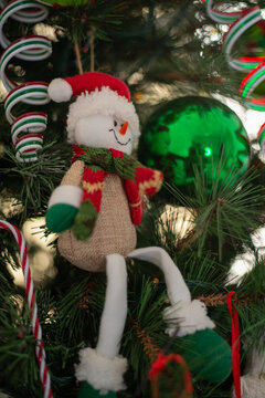 Snowman With Christmas Cap And Green Ball On A Christmas Tree