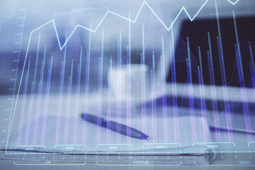 Double exposure of financial graph drawings and desk with open notebook background. Concept of forex market