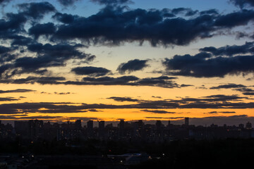 Beautiful sunset and clouds in the sunset orange and blue sky, big city view