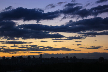Beautiful sunset and clouds in the sunset orange and blue sky, big city view