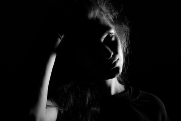 Black and white portrait of an Italian young woman on black background - obrazy, fototapety, plakaty