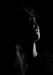 Black and white portrait of an Italian young woman on black background