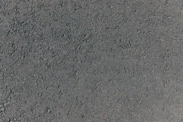 Top view of dark asphalt on the street. Texture grey asphalt background. Surface grunge rough asphalt. Car road, pavement, tile. Granular abstract uniform grainy surface.  Wallpaper