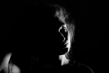 Black and white portrait of an Italian young woman on black background