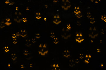Creative abstract background with bokeh in the shape of face Jack-o-lantern.Halloween background.