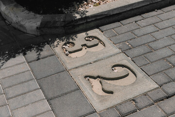 Parking place with 32 number. Close-up of a number marking in a parking lot. Empty parking lot, individual parking. Top view. .