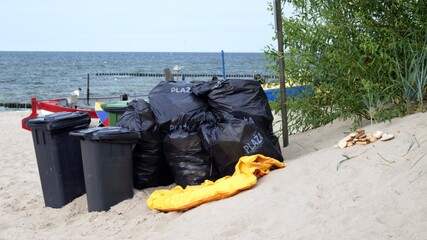 Bags full of rubbish from the beach, ready to be taken away.