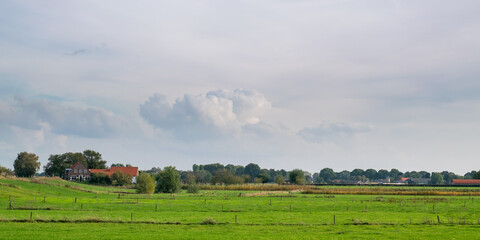 Fototapeta na wymiar Old farmhouse standing in polder