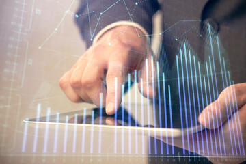 Multi exposure of man's hands holding and using a phone and financial chart drawing. Market analysis concept.