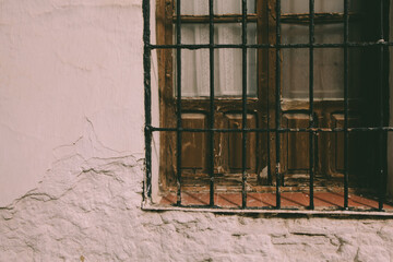 Old dusty window in the wall of a house.