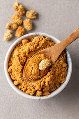 Mulberry Fruit Powder. A bowl of dried mulberry powder and dried mulberry fruit.