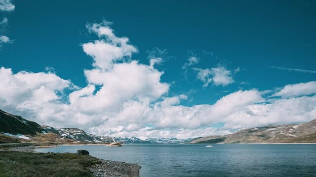 Oppland, Tyin Lake, Norway. Stones On Coast Of Beautiful Lake Tyin In Summer Day. Norwegian Nature. 4K