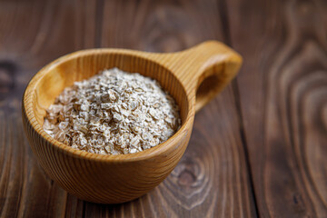 Wooden Cup with oatmeal. Health food. Wood texture
