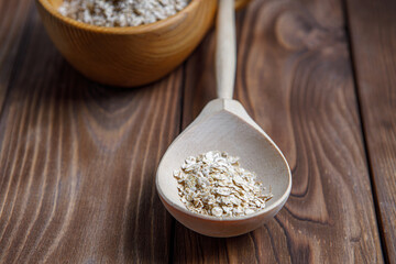 Wooden Cup and spoon with oatmeal. Health food. Wood texture
