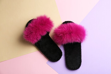 Pair of soft slippers on color background, flat lay