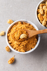 Mulberry Fruit Powder. A bowl of dried mulberry powder and dried mulberry fruit.