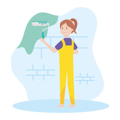 painter worker woman paints the wall with paint roller remodeling