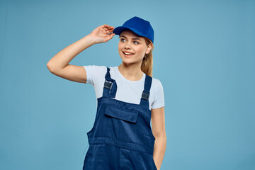 Woman in work uniform blue cap carriage delivery service courier blue background