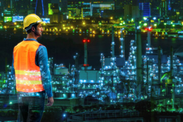 Double exposure of engineer young man wear safety helmet while looking at something over on oil refinery industry plant background