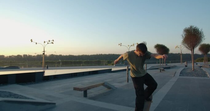 Skateboarding tricks, skater boy is bouncing off of a park bench, 4k