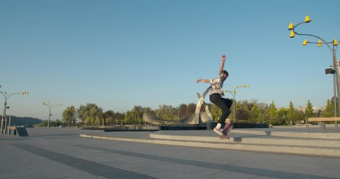 Skater boy is doing tricks at the park, kickflip and jumps, 4k