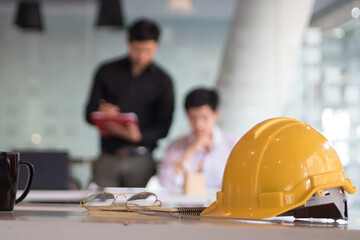 Close up view of engineer worktable with safety helmet, copy space and measuring tool on white desk...