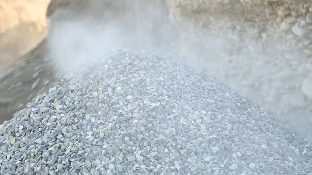 crushed stone fills and rolls through the dust