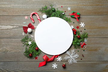 Flat lay composition with Christmas decor and blank card on wooden background. Space for text