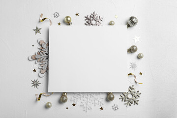 Flat lay composition with Christmas decor and blank card on white background. Space for text