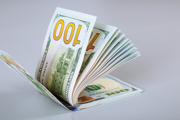 American dollars on a gray background. One hundred dollar bills.