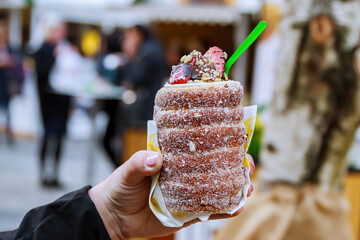 National street food of the Czech Republic. Baking popular trdlo at the street stalls.