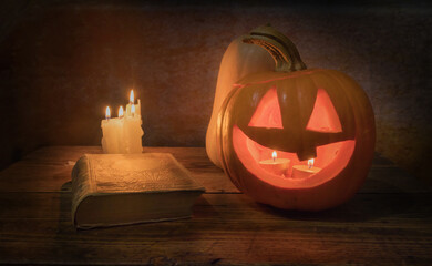 Pumpkin, candles and old book. Halloween still life