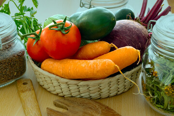 Tomato, green pumpkin, cucumber, beet and carrot in a tiny basket