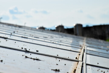 Photovoltaic system on the roof of the building, sustainable concept.
