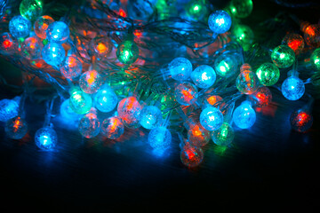 Spherical led light bulbs with tangled wires. Christmas garland multi-colored glow in the dark