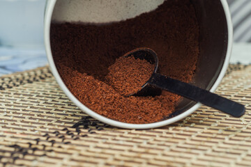 coffee with a measuring spoon in a jar on the table