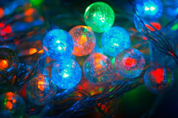 Spherical led lights close-up. Christmas garland glowing in the dark