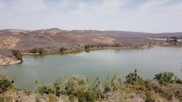 Tracking Shot Through window of  Ancient Ranthambore Fort to Wide Shot of Rajbagh Lake, Rajasthan, India
