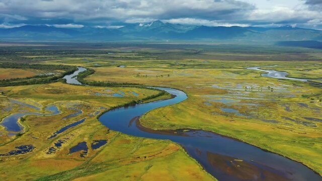 Aerial view of Avacha river delta and hilly landscape, Kamchatka Peninsula, Russia, 4k