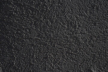Still-life. Photo of the wall surface with streaks and lumps of plaster. In black and white shades.