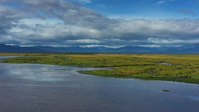 Aerial view of Avacha river delta and hilly landscape, Kamchatka Peninsula, Russia, 4k
