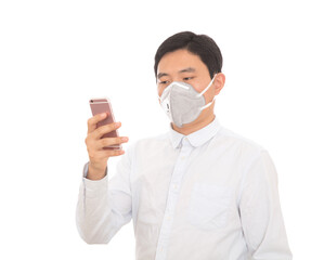 A man wearing a mask is using a mobile phone