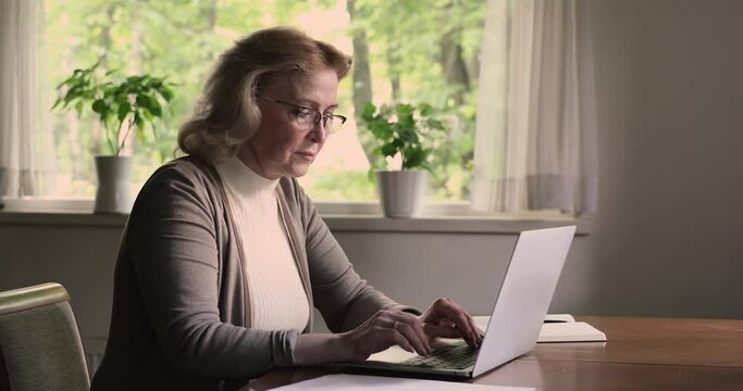 50s woman at home using laptop experiences problems with wireless device feels angry. Computer access operation denied, wrong or forgot password error need help, older generation, modern tech concept