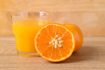 Fresh Honey Murcott orange fruit and juice on wooden background