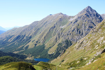 A bright blue lake hidden among mountains and forests