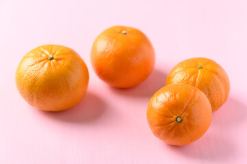 Fresh Honey Murcott orange fruit on pink background