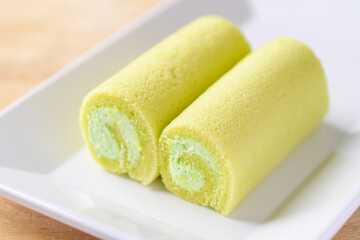 Pandan roll cake on white dish