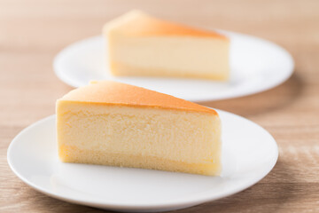 Slice of vanilla cheesecake on white plate